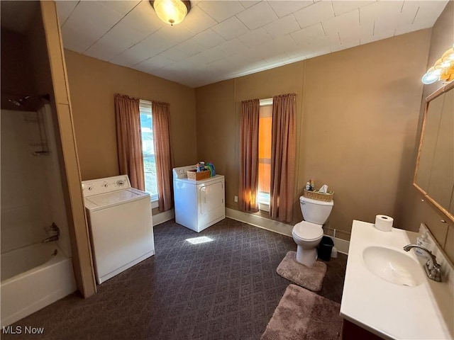 full bathroom featuring vanity, washtub / shower combination, independent washer and dryer, and toilet