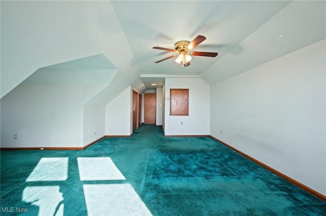 additional living space with ceiling fan, lofted ceiling, and dark carpet