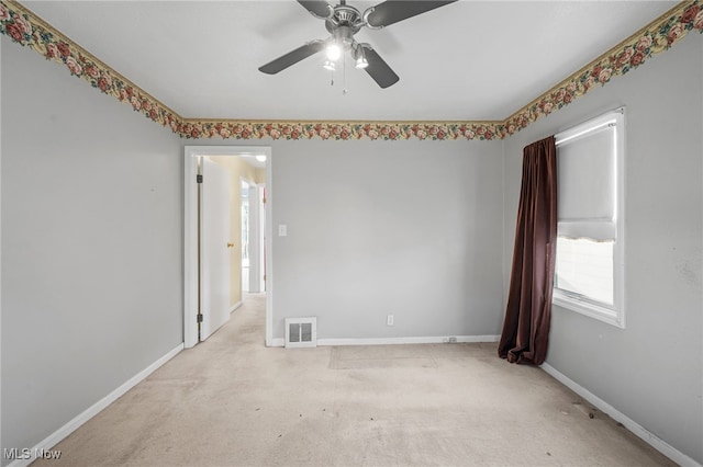 empty room featuring light colored carpet and ceiling fan