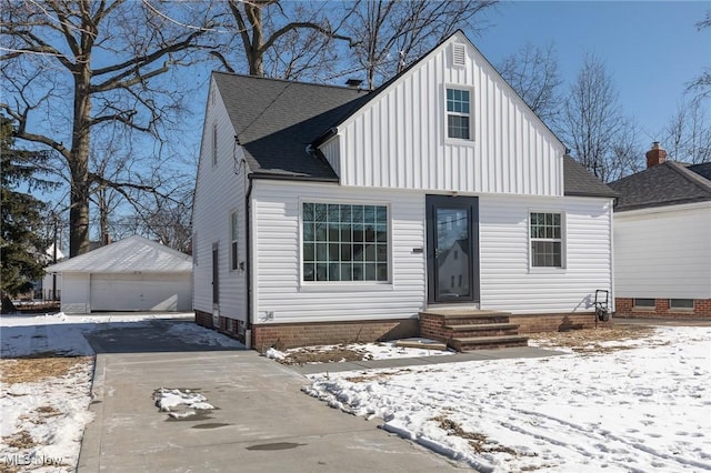 view of front of home with a garage and an outdoor structure