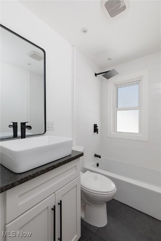 full bathroom featuring vanity, tile patterned flooring, tub / shower combination, and toilet