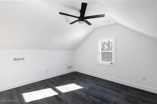 bonus room with vaulted ceiling, ceiling fan, and dark hardwood / wood-style flooring