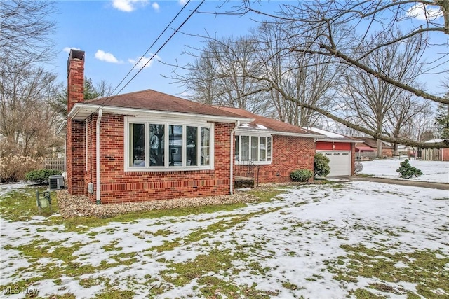 exterior space featuring cooling unit and a garage