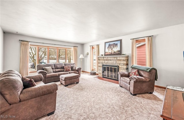 living room featuring light carpet and a fireplace