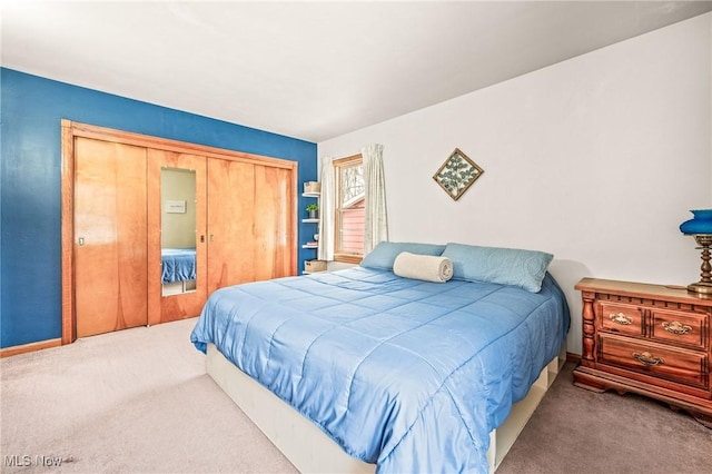 carpeted bedroom with a closet