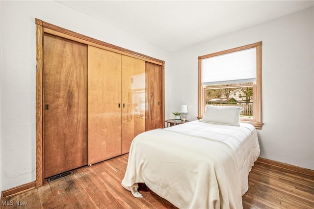 bedroom featuring wood-type flooring and a closet