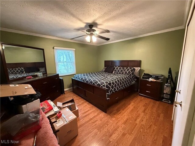 bedroom with crown molding, ceiling fan, a textured ceiling, and light hardwood / wood-style floors