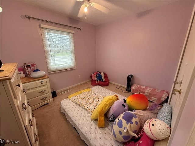 bedroom with light carpet and ceiling fan