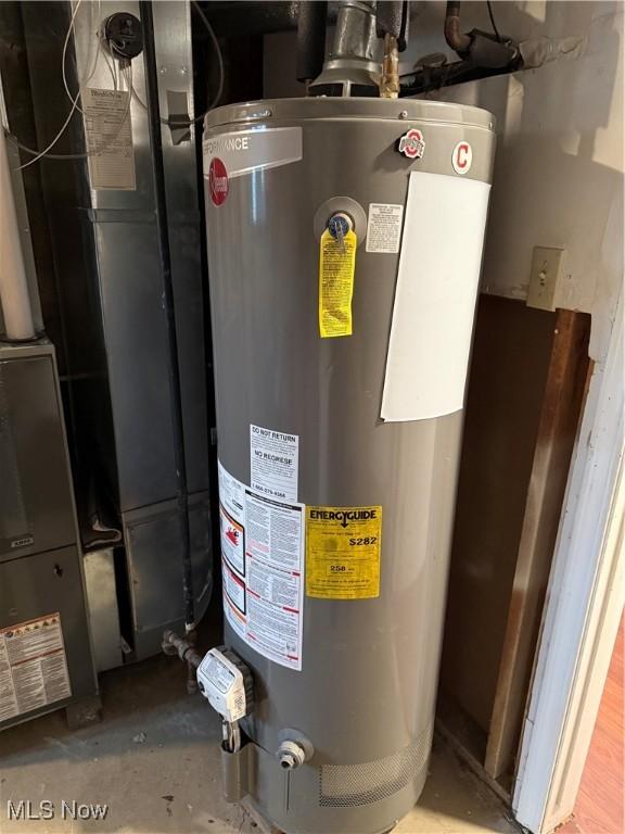 utility room featuring water heater