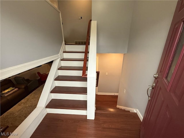 staircase with hardwood / wood-style flooring