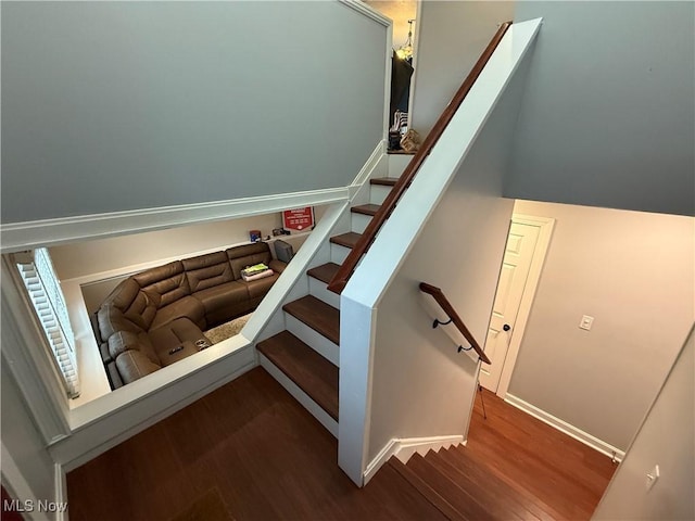 stairs featuring hardwood / wood-style floors