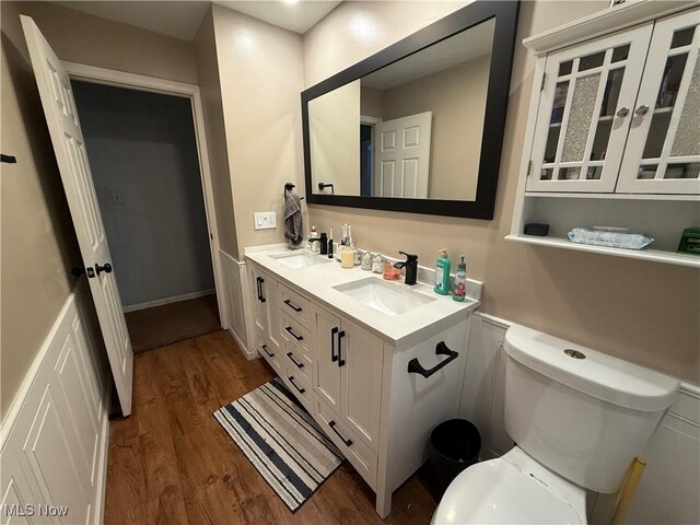 bathroom with vanity, toilet, and wood-type flooring