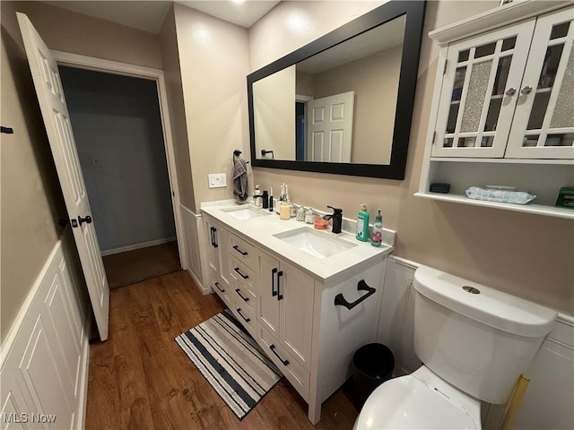 bathroom with vanity, wood-type flooring, and toilet