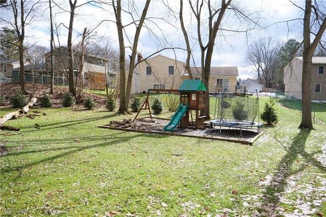 view of playground featuring a trampoline and a lawn