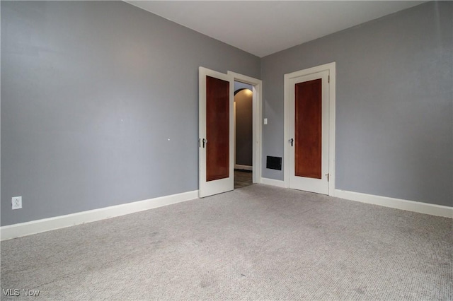 spare room featuring light carpet