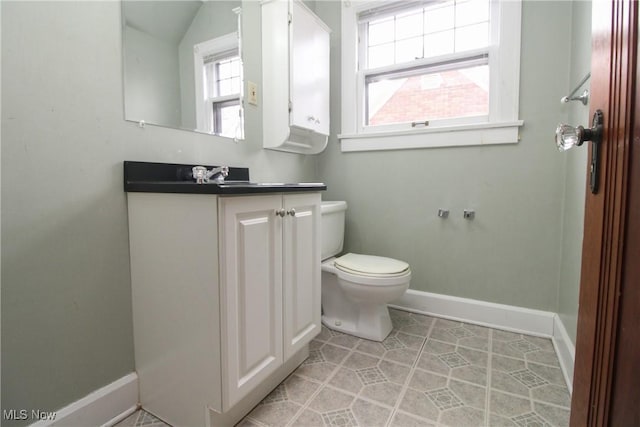 bathroom with vanity, toilet, and tile patterned flooring