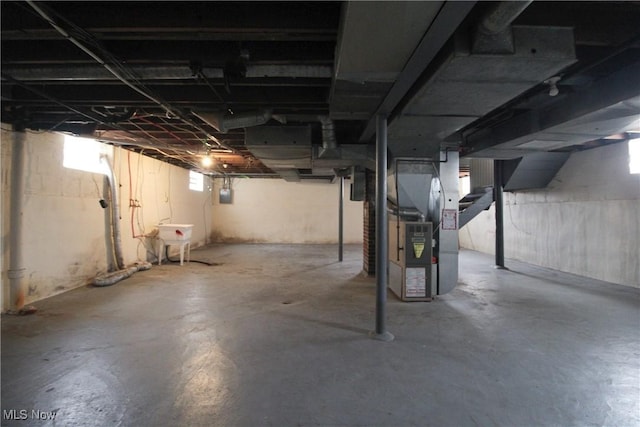 basement featuring sink and heating unit