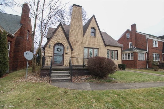 tudor home with a front yard