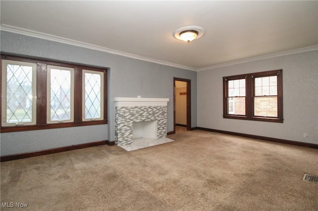 unfurnished living room with a tile fireplace, ornamental molding, and light carpet