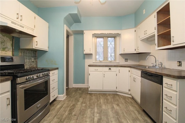 kitchen featuring stainless steel appliances, white cabinetry, and sink