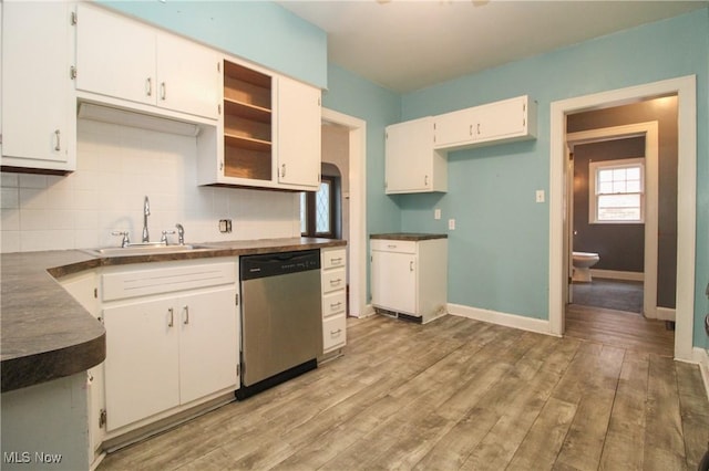 kitchen with sink, light hardwood / wood-style flooring, dishwasher, white cabinetry, and backsplash