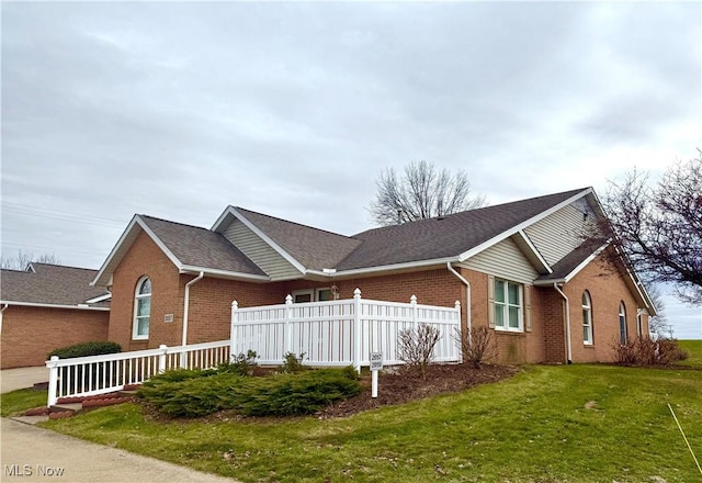 view of side of property featuring a lawn and a porch