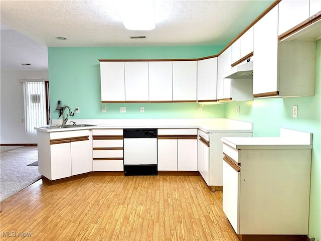 kitchen featuring dishwasher, sink, kitchen peninsula, and white cabinets