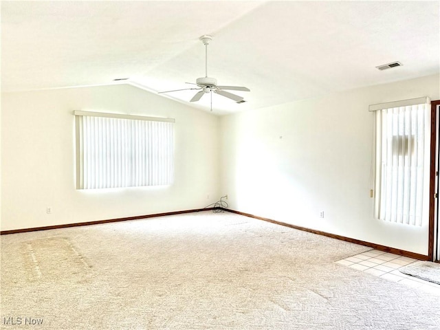 carpeted empty room with ceiling fan and vaulted ceiling