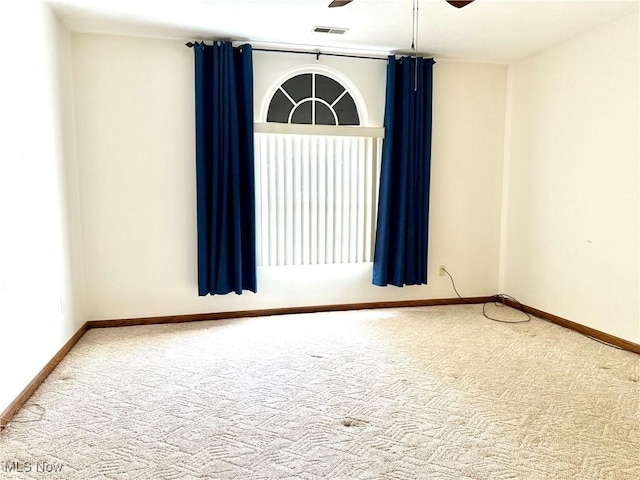 empty room with carpet and ceiling fan