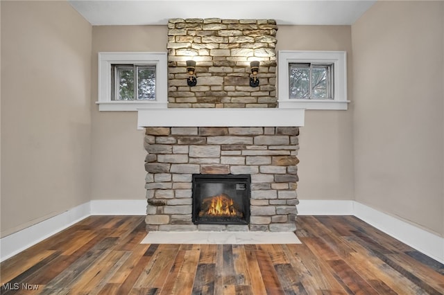 details with a fireplace, baseboards, and wood finished floors