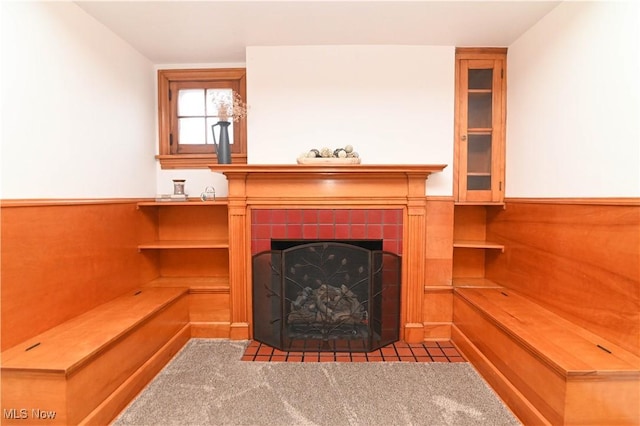 living room with a fireplace and light carpet