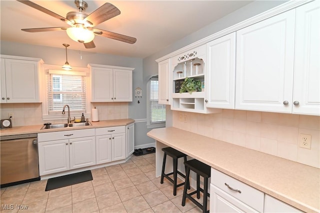 kitchen with sink, ceiling fan, dishwasher, white cabinets, and light tile patterned flooring