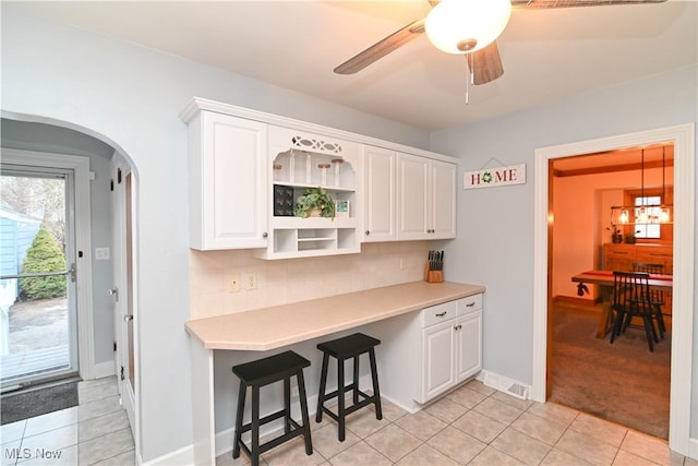 kitchen with white cabinetry, tasteful backsplash, and light tile patterned flooring