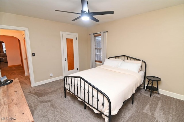 bedroom featuring dark carpet and ceiling fan