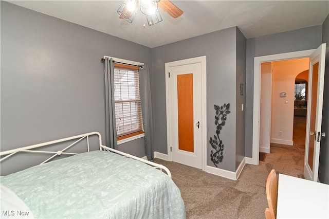 bedroom with ceiling fan and light colored carpet