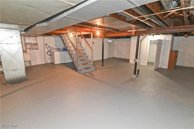 basement with washer and clothes dryer and sink