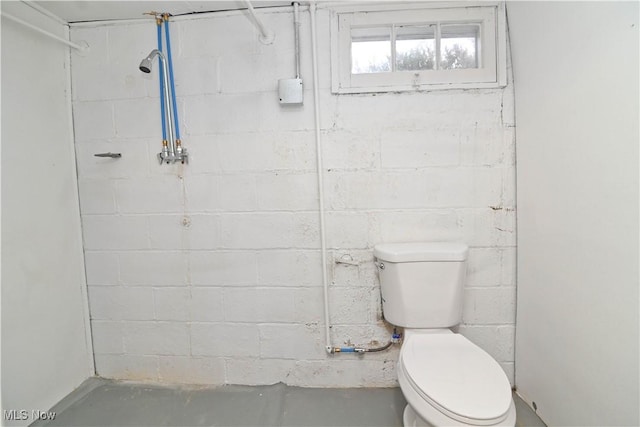 bathroom featuring toilet and concrete flooring