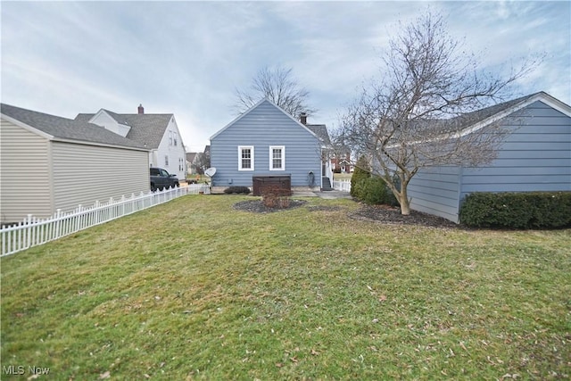 rear view of house featuring a yard