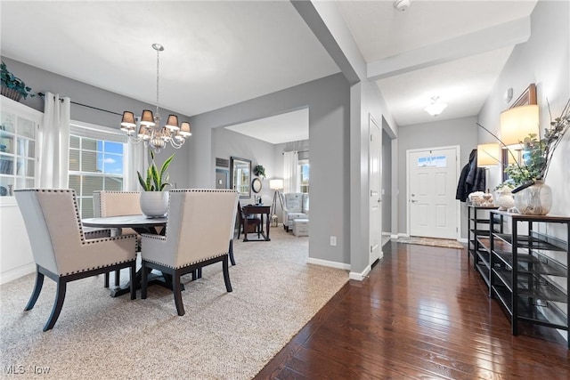 dining room with dark hardwood / wood-style flooring and a notable chandelier