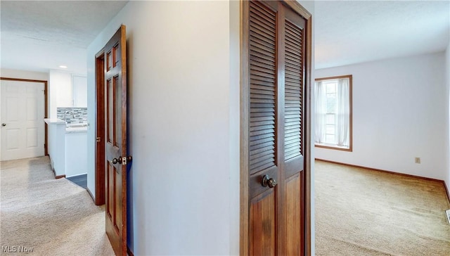 corridor with light colored carpet