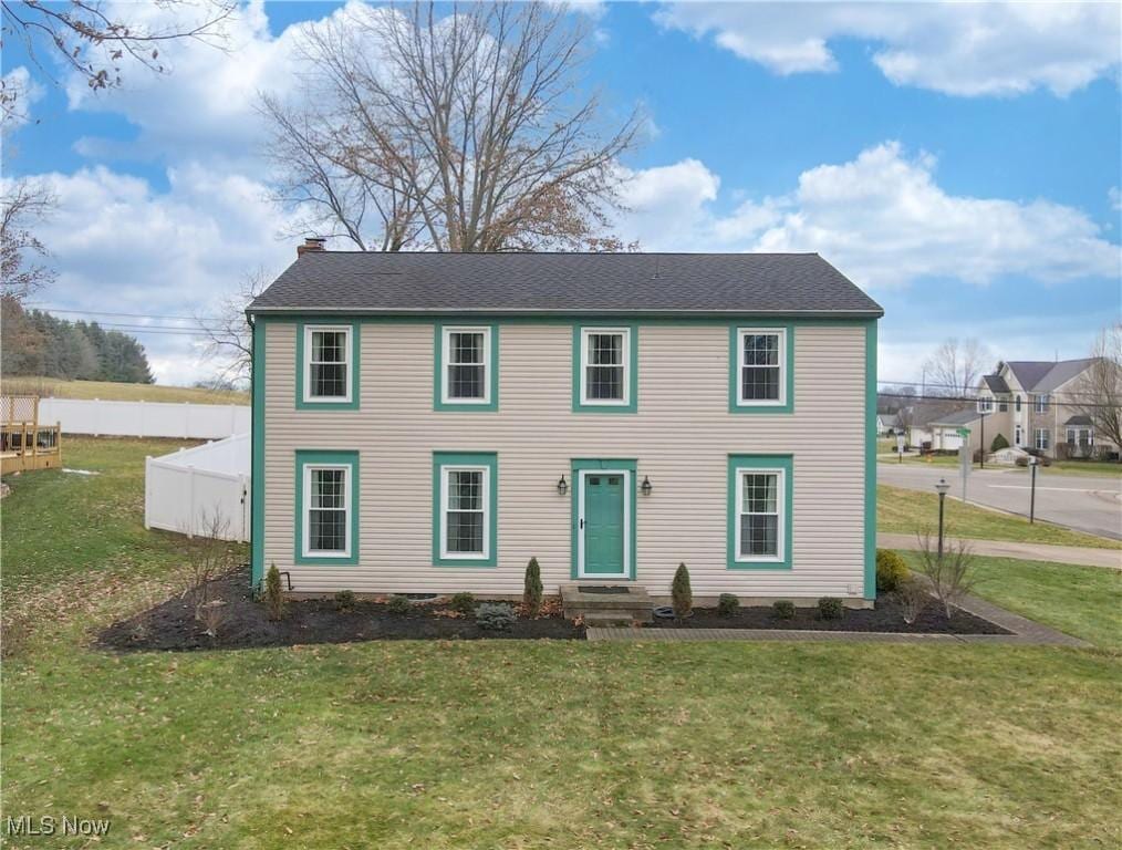 colonial-style house with a front lawn