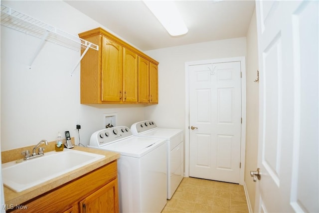 clothes washing area featuring cabinets, independent washer and dryer, and sink