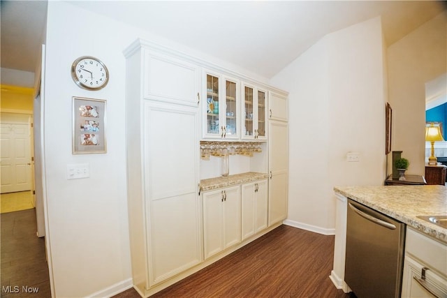 kitchen featuring dishwasher, light stone countertops, white cabinets, dark hardwood / wood-style flooring, and vaulted ceiling