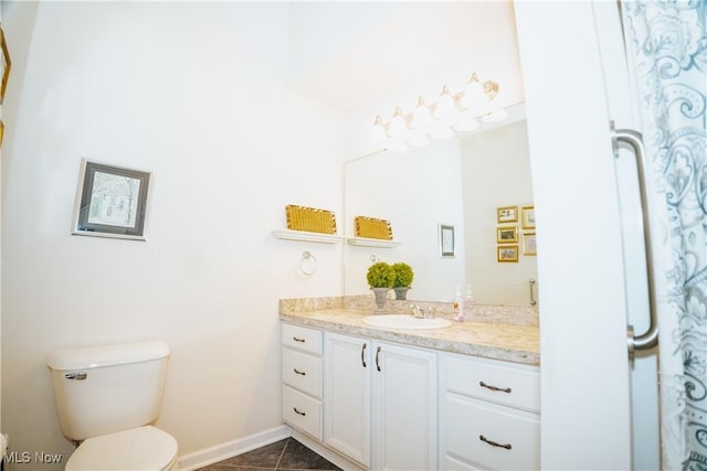 bathroom featuring vanity, tile patterned flooring, and toilet