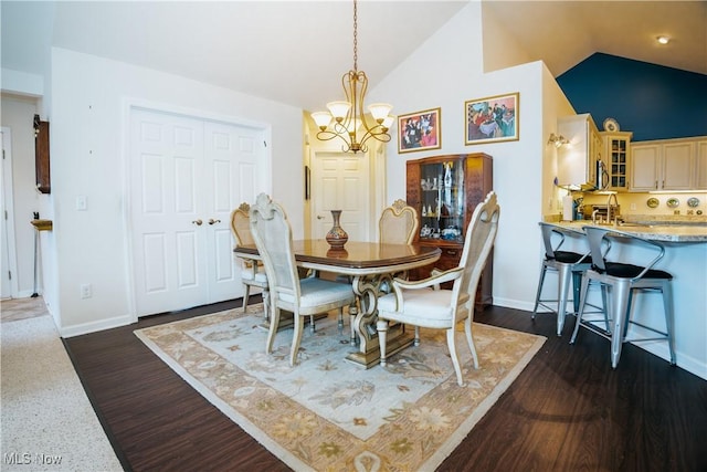 dining area featuring an inviting chandelier, high vaulted ceiling, and dark hardwood / wood-style floors