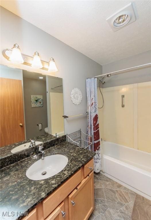 full bathroom with vanity, shower / bath combination with curtain, and toilet