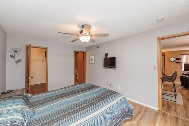 bedroom with ceiling fan, a closet, and light wood-type flooring