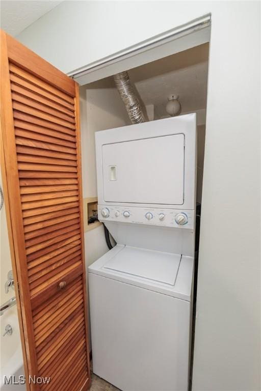 laundry area with stacked washer and clothes dryer