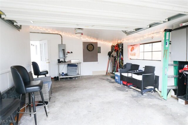 garage with a garage door opener and electric panel