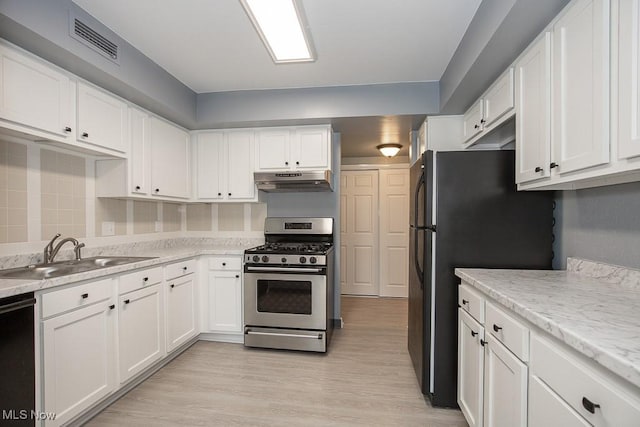 kitchen featuring white cabinetry, sink, backsplash, black appliances, and light wood-type flooring